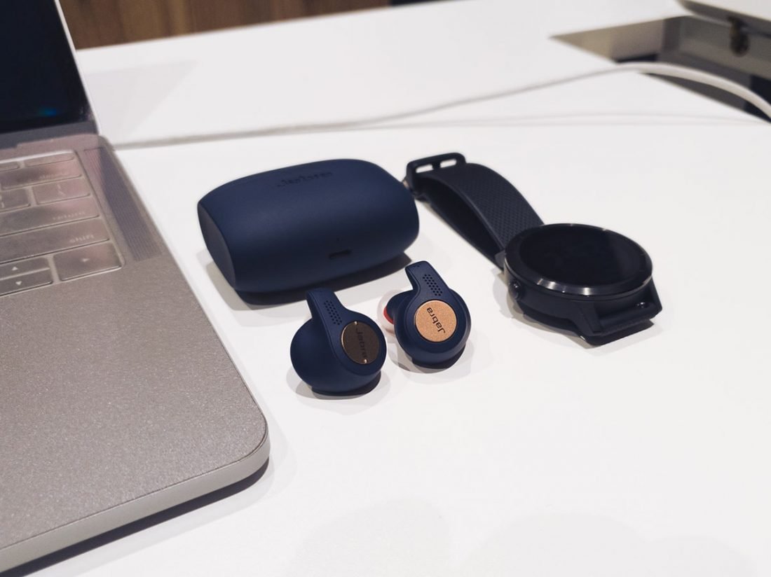 Jabra Elite Active 65t's Earbuds on the table with its case and watch