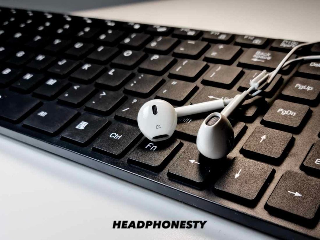Apple earbuds on a computer