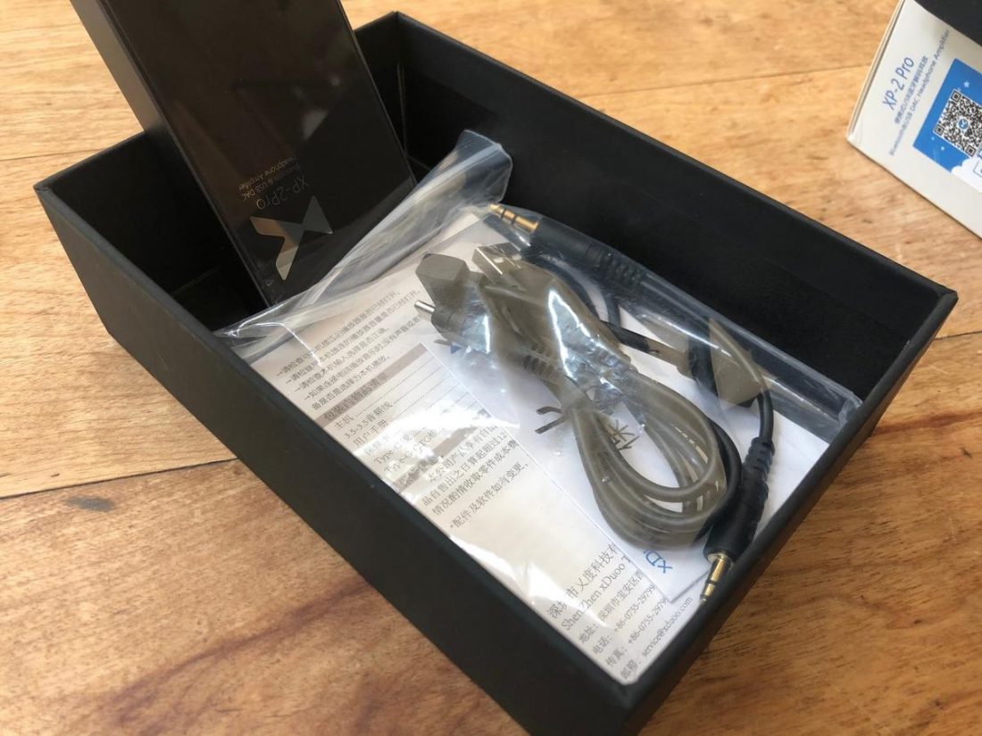 The included accessories include a short dual 3.5mm audio cable for the AUX input, a short dual USB-C cable for tethering to a compatible phone or DAP, and a long USB-A to USB-C cable for charging or for connecting to a computer.