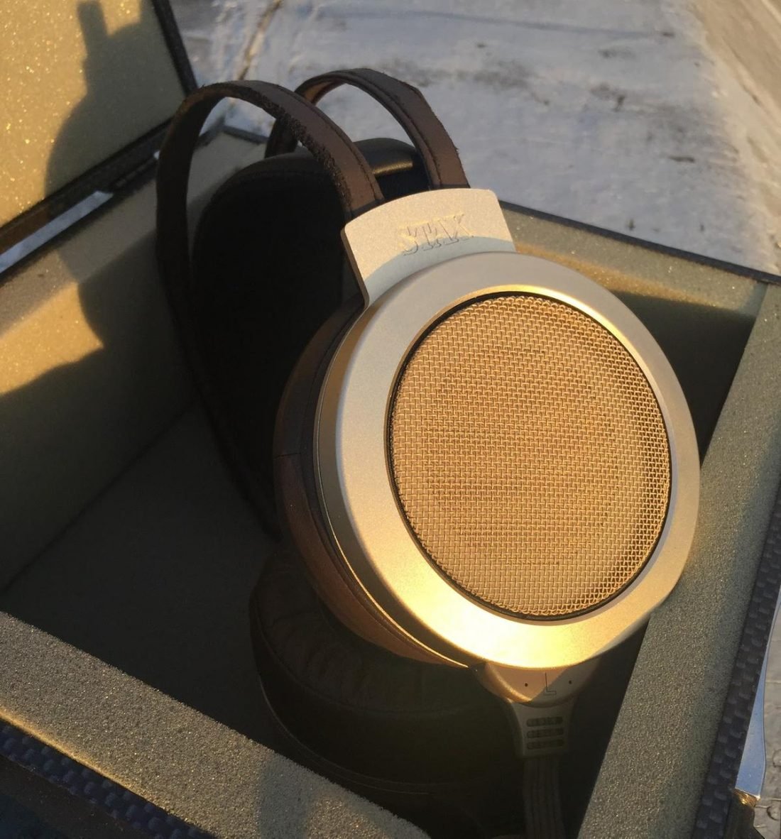 The SR-007's precisely-machined metal earcups catch the light of the setting sun