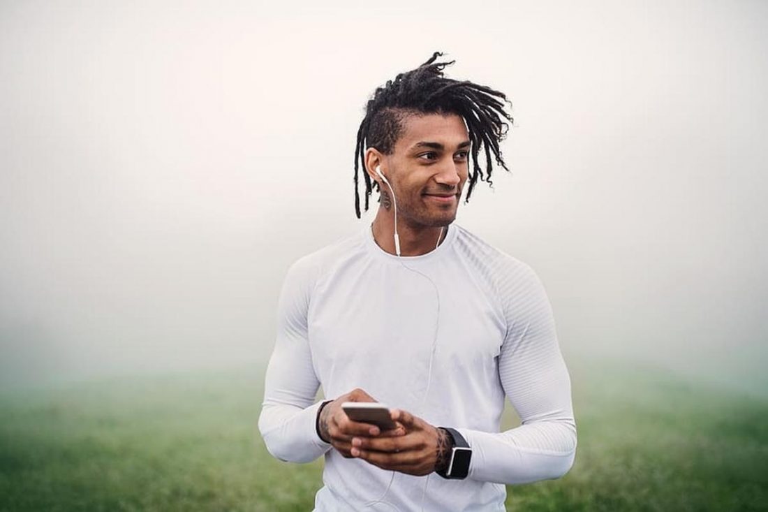 Fit man in white listening to music while jogging (From: Pxfuel.com)
