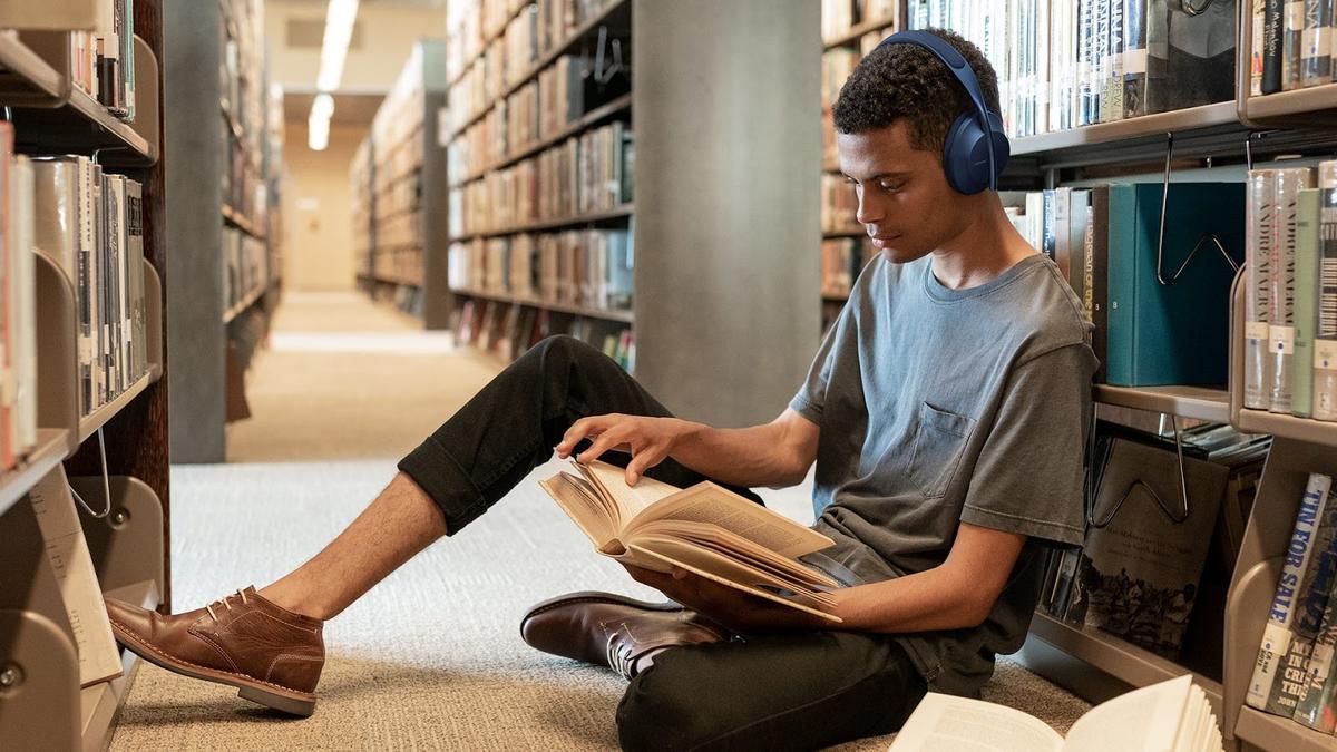Boy reading while listening using Bose 700 (From: Bose)