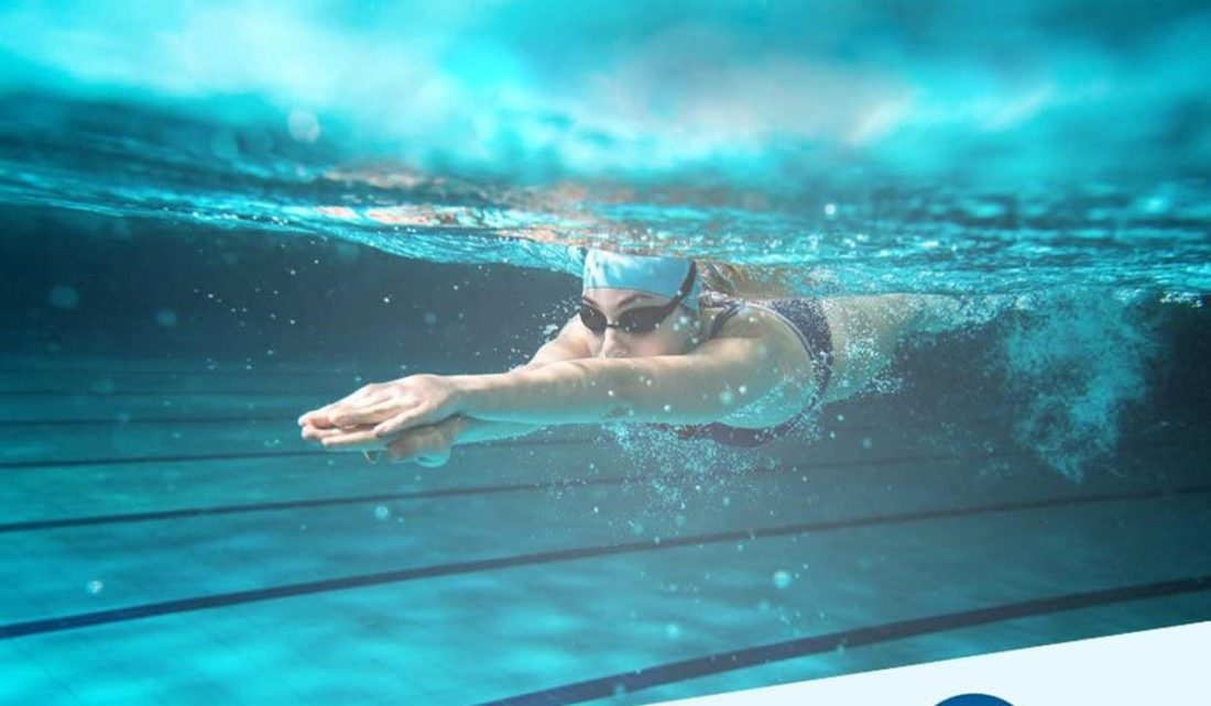 Person swimming with SWMIUSK Waterproof Headphones (From: Amazon)