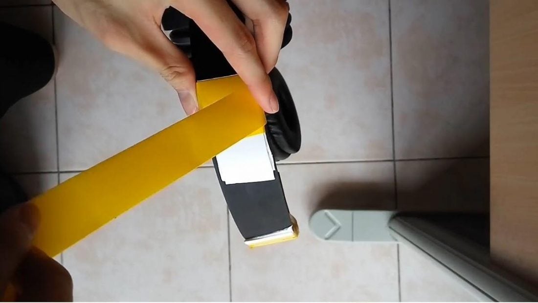 Wrapping tape around the broken headband area of the headphones. (From: Youtube/Cian Xan Teoh)
