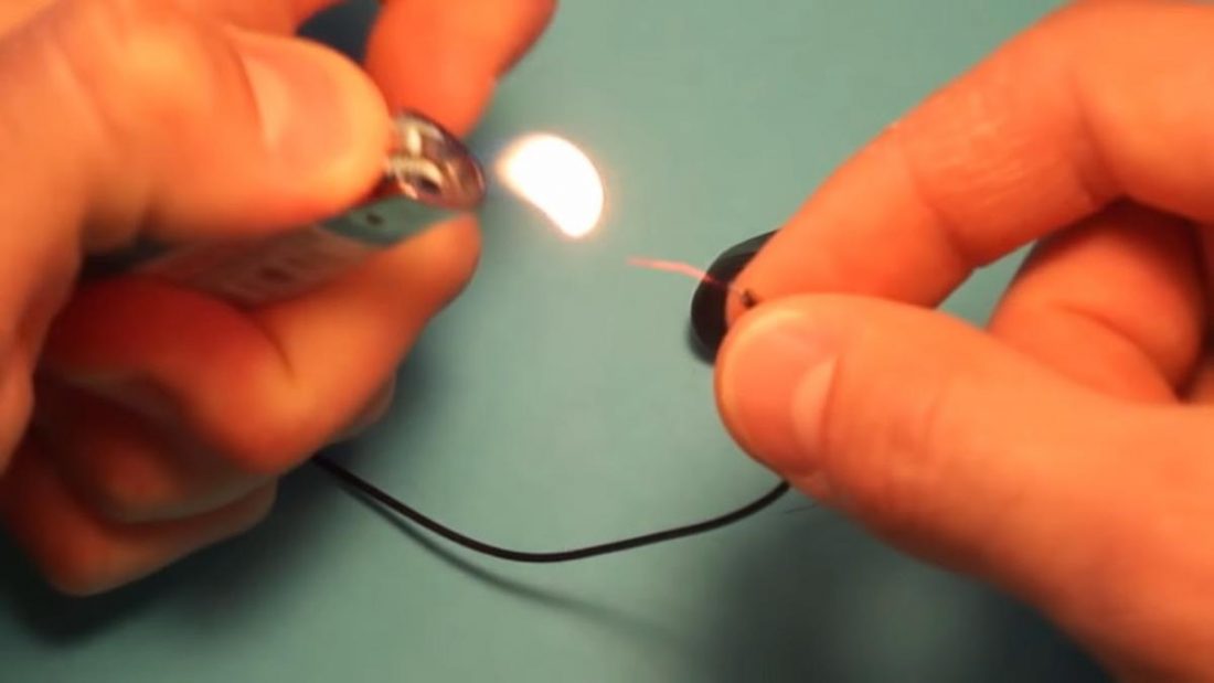 Burning off enamel from earphone wiring (From: RichsMethods/YouTube)
