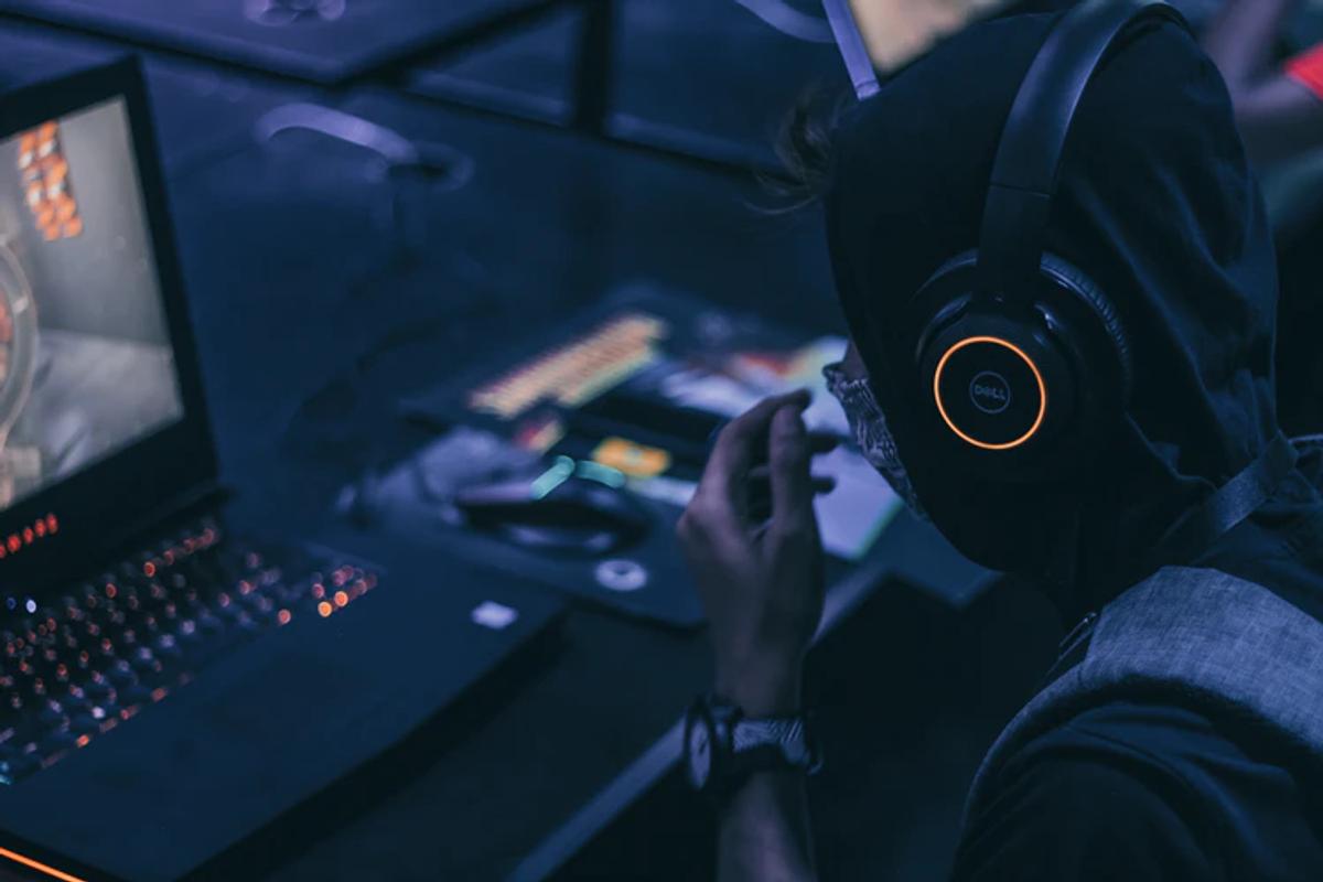 Boy wearing headphones while gaming (From: Unsplash)