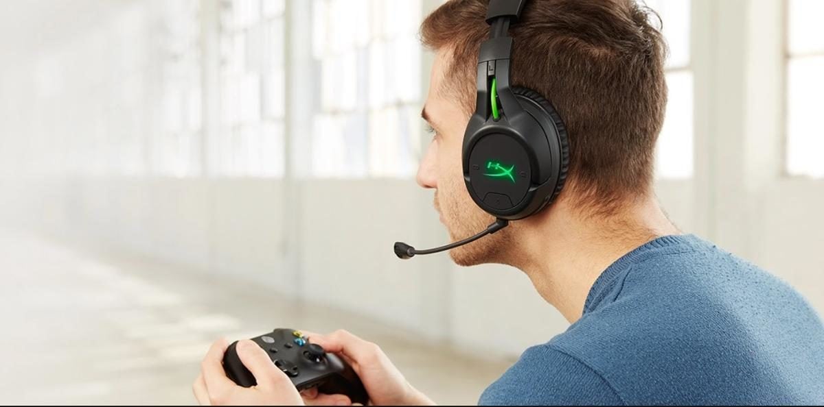Man playing Xbox with wireless headphones (From: HyperXGaming)