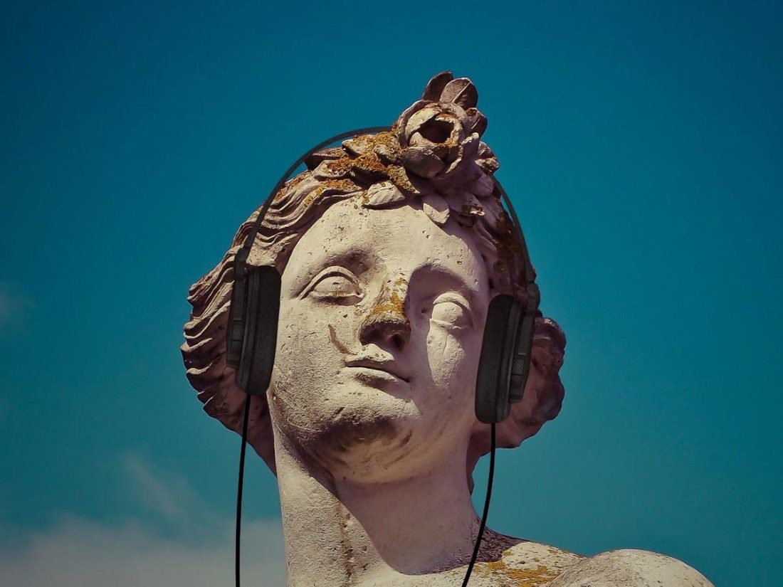 Stone sculpture wearing headphones (From: Pixabay)