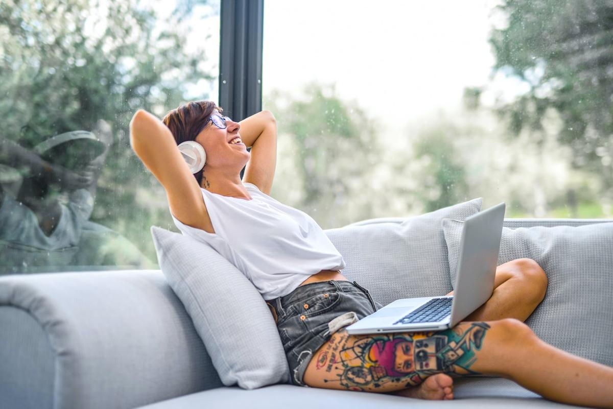Woman enjoying wireless headphones connected to PC (From: Pexels)