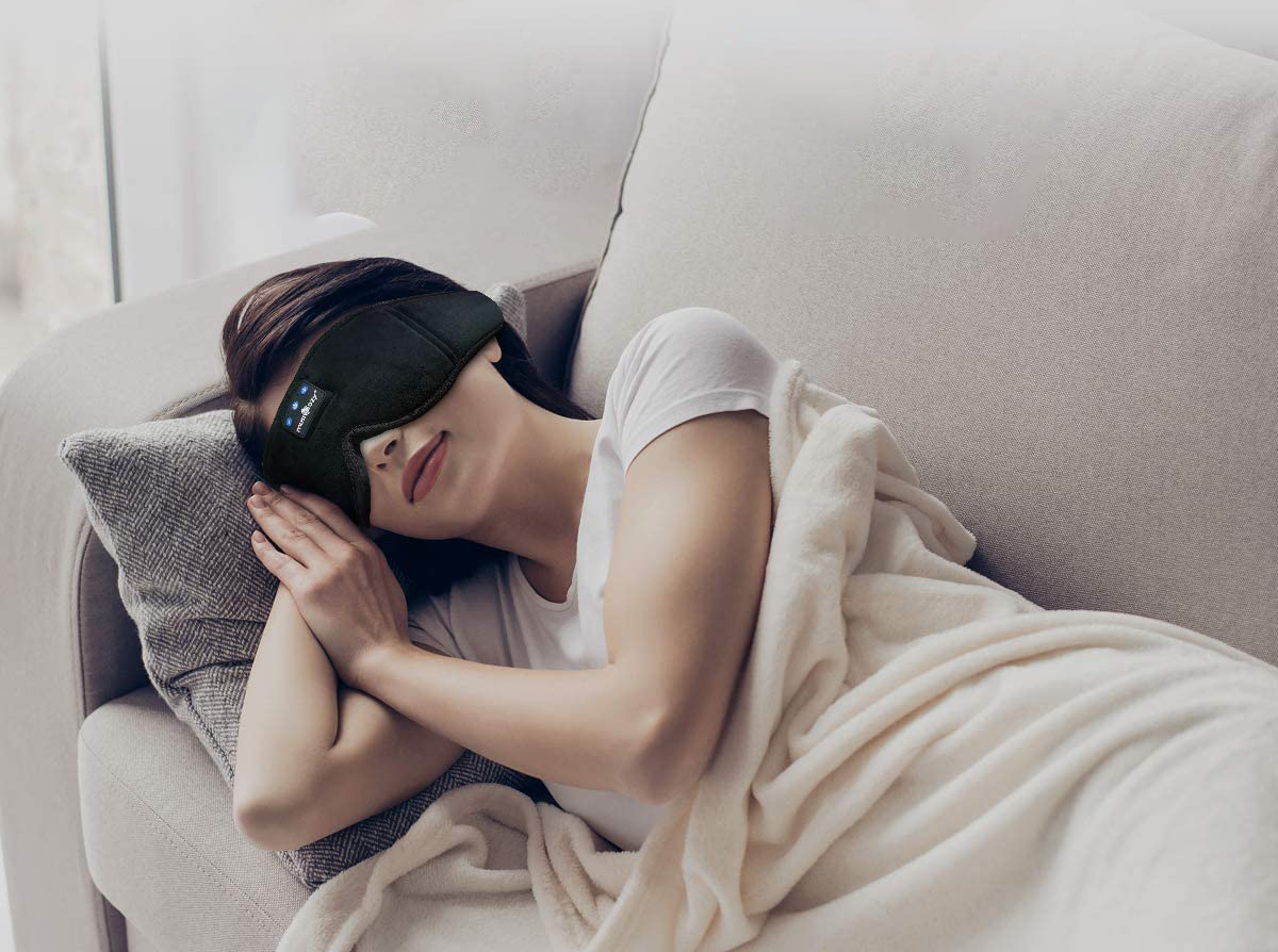 Woman wearing Sleep Mask with Headphones while sleeping (From: Amazon)