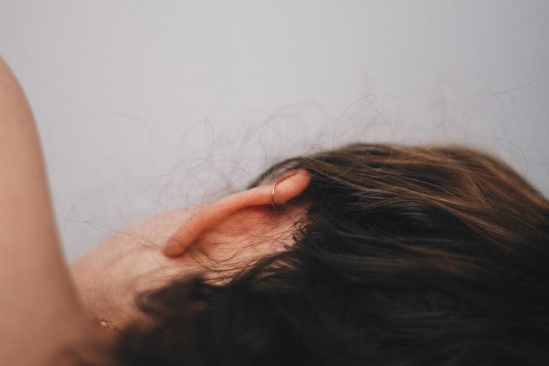 A woman resting without earbuds on. (From: Unsplash)