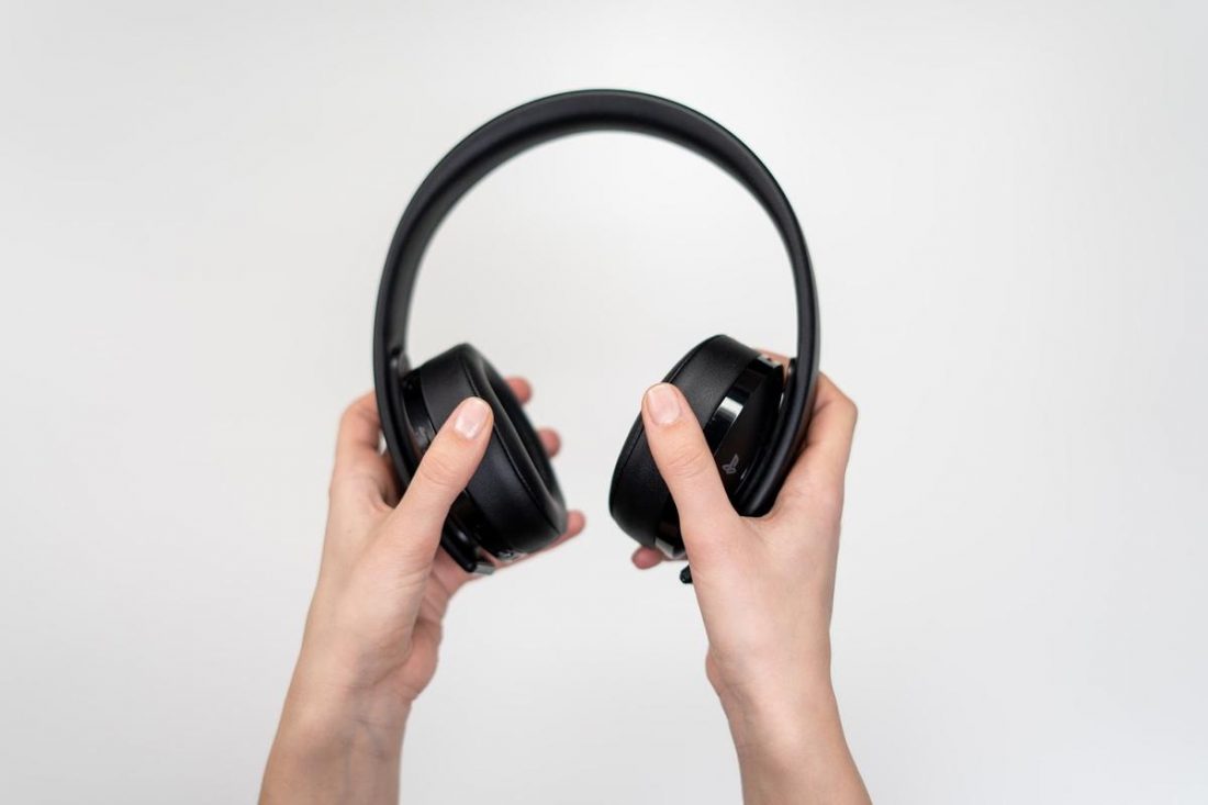 Hands holding headphones (From:Pexels).