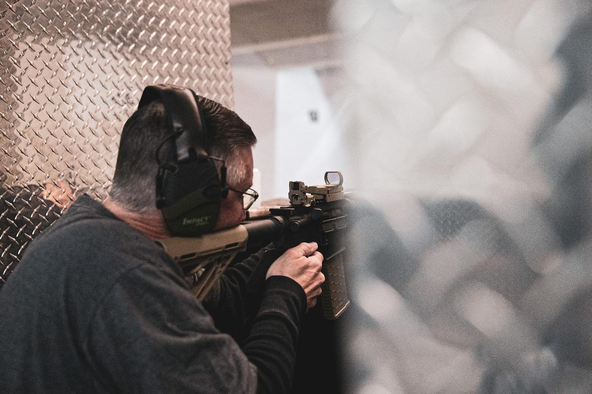 Man wearing hearing protection while shooting (From: Pixabay)