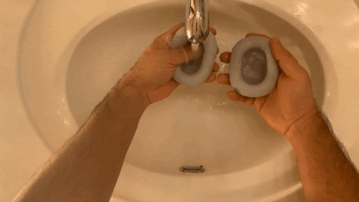 Rinsing the ear cushions under water. (From: GYM Sweat YouTube)