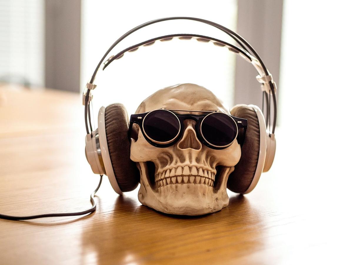 A figurine of a skull wearing headphones. (From: Unsplash)