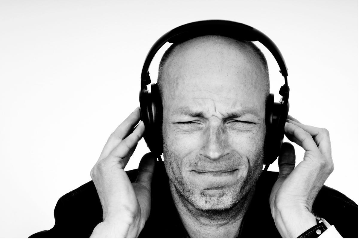 Man hearing headphones crackling