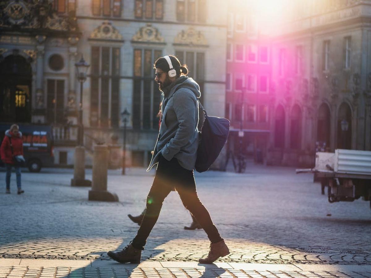 Man walking outside while listening to music (From: Pexels)