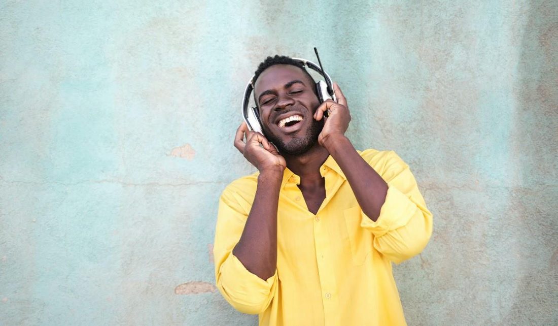 Man enjoying radio headphones (From: Pexels)