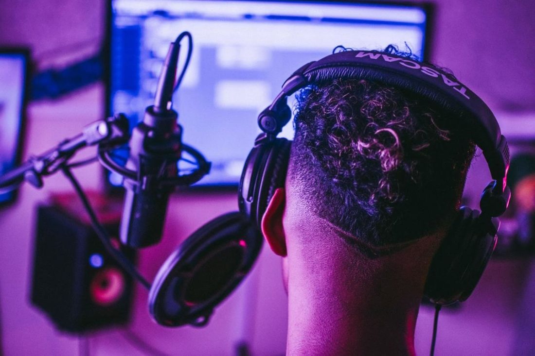A man wearing comfortable headphones while mixing audio. (From: Pexels)