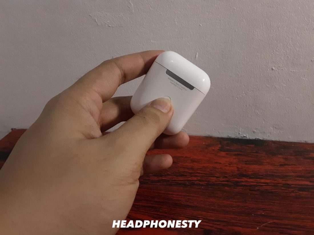 Pressing the Apple AirPods button