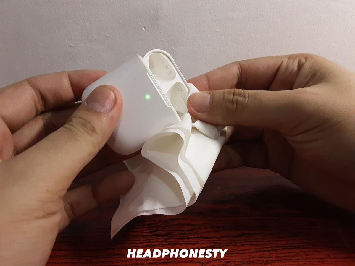 Wiping AirPods with a paper towel