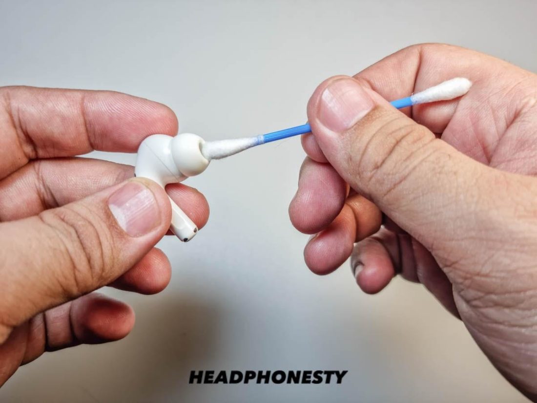 Cleaning AirPods with cotton swab