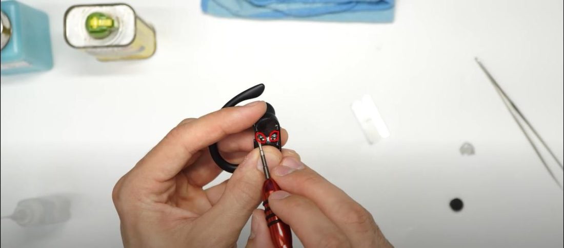 Using flathead screwdriver to remove adhesive (From: YouTube/Joe's Gaming & Electronics)