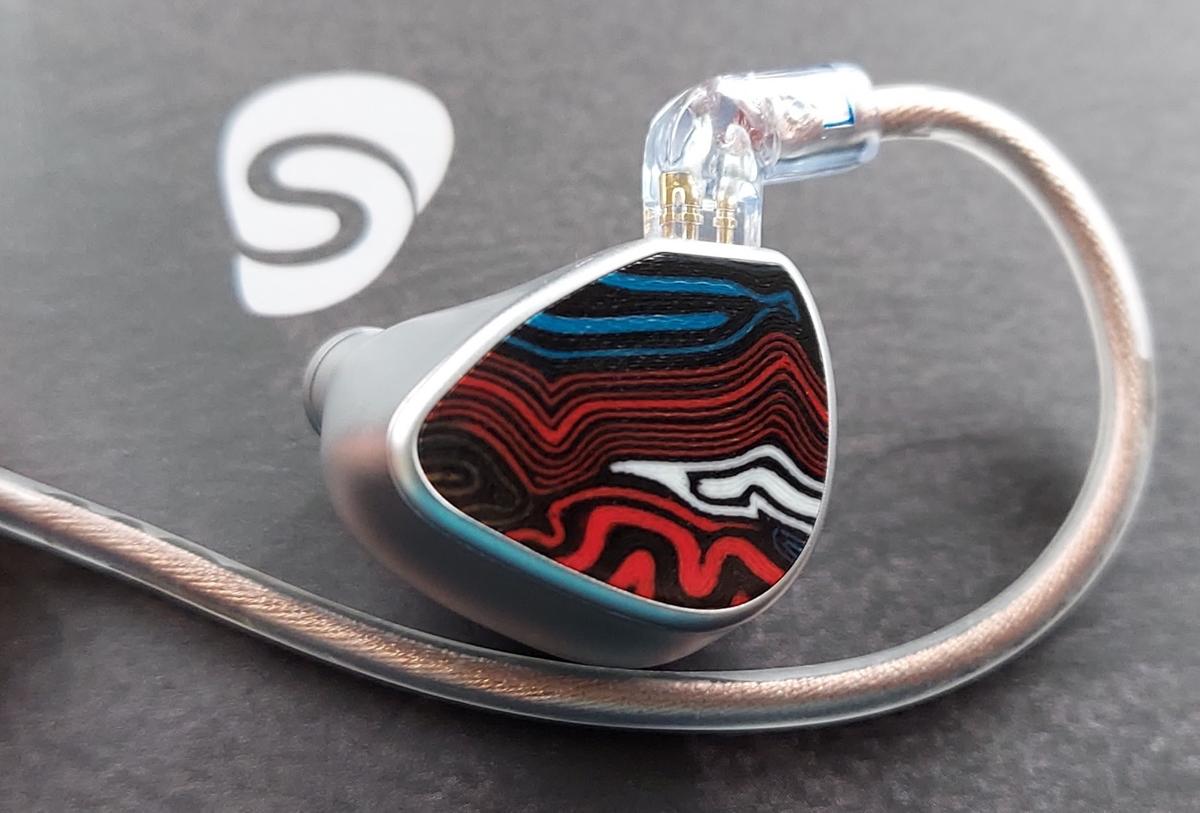 The artistic and unique EJ07M, shown in silver with a multi-color acrylic faceplate.
