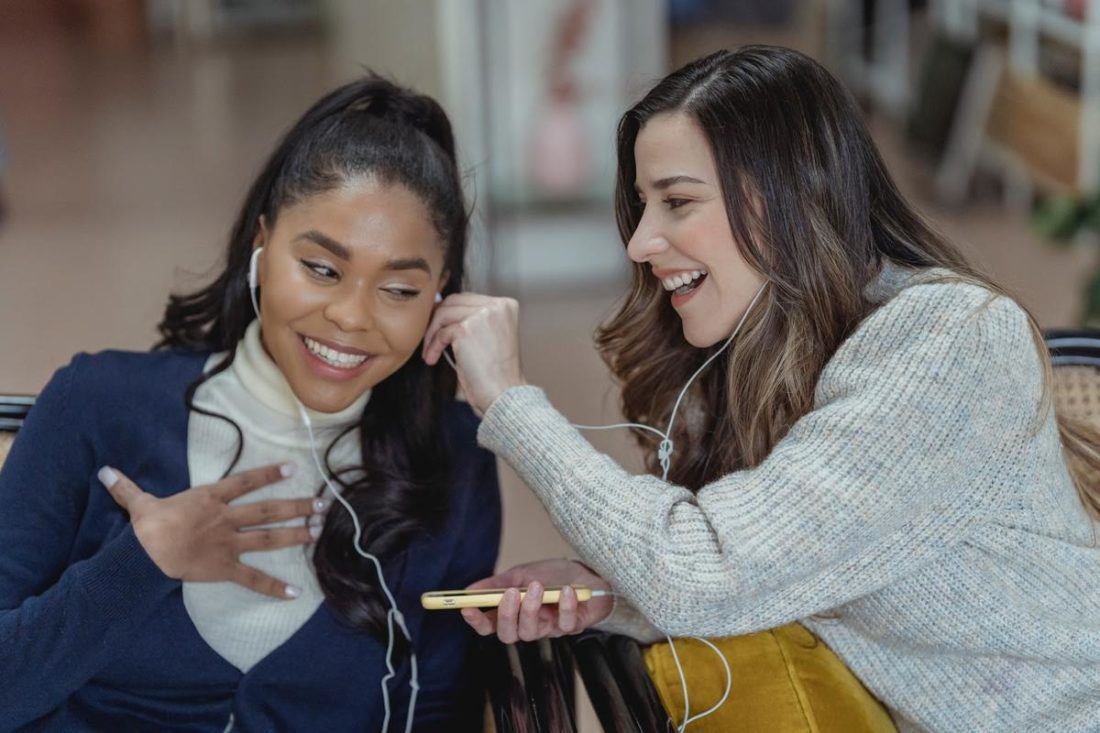 Like many friends, these two are sharing headphones, but the practice isn't necessarily safe. (From: Pexels/George Milton)