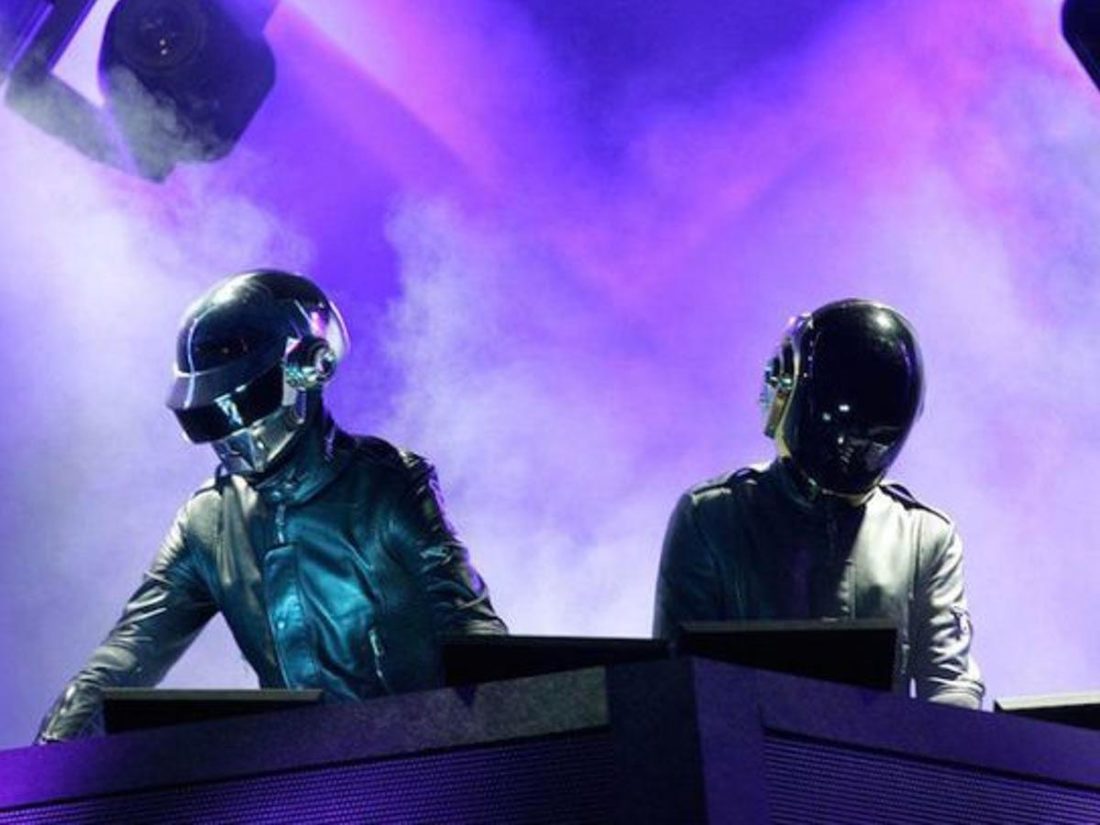Daft Punk performing with their signature helmets