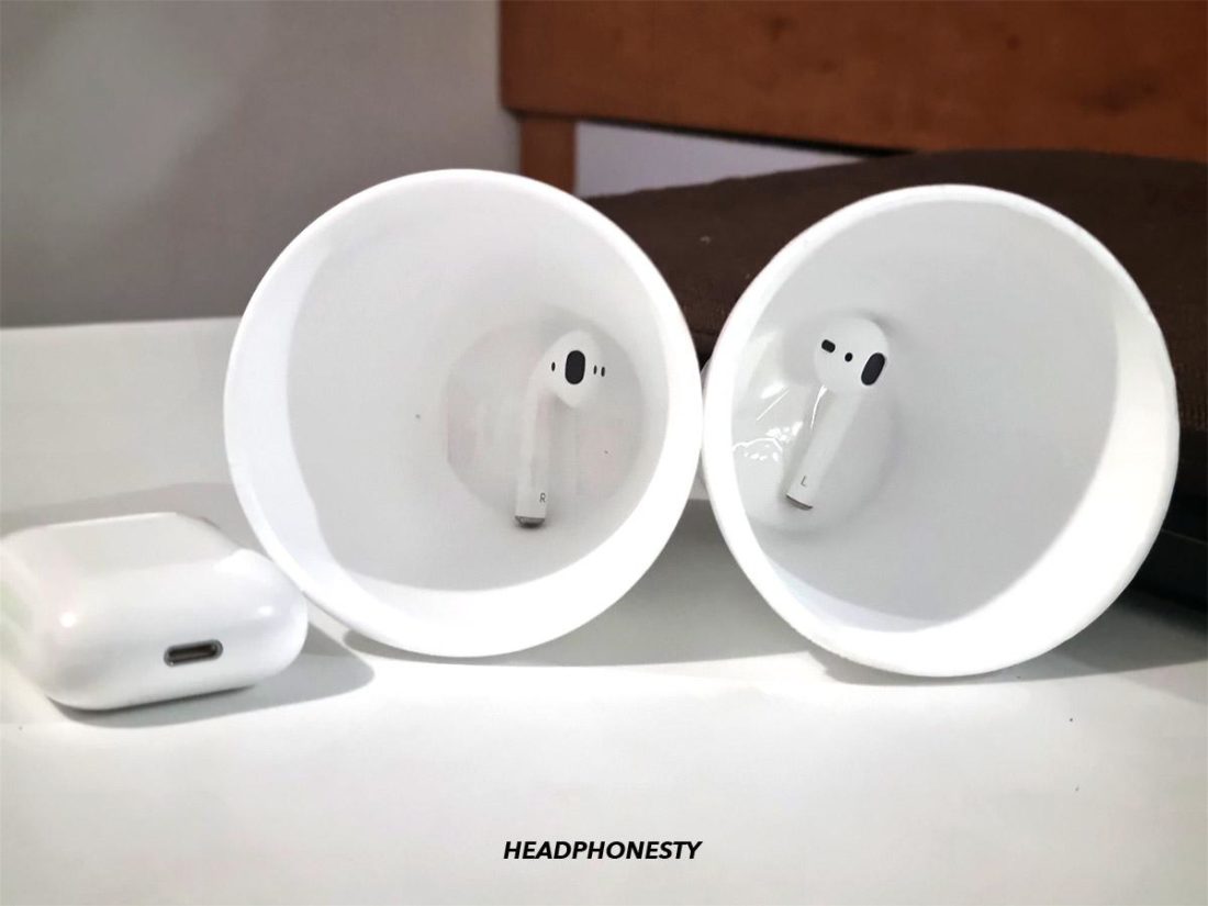 Placing AirPods at the bottom of paper cup