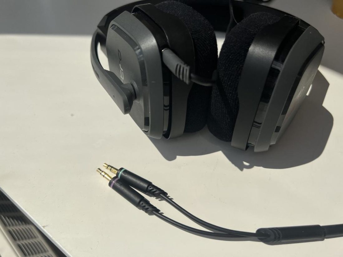 Close up at where the A10 3.5mm cable connects to the headset and the additional Y splitter adapter for PC.