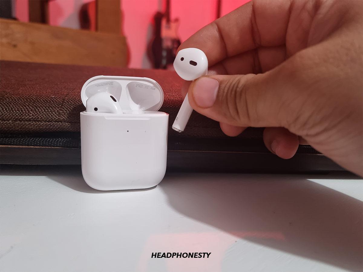 Taking one AirPod from case to attempt reset