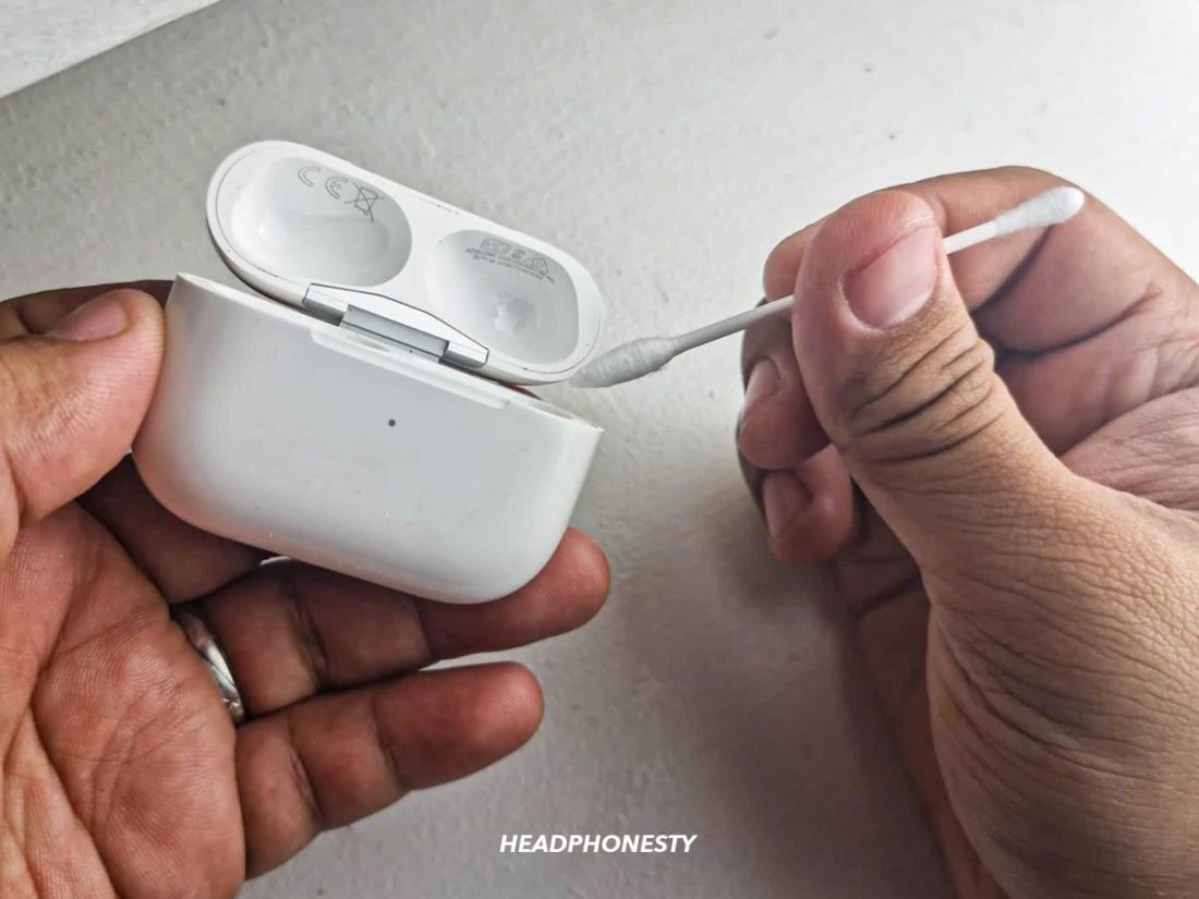 Cleaning the AirPods case with cotton swab