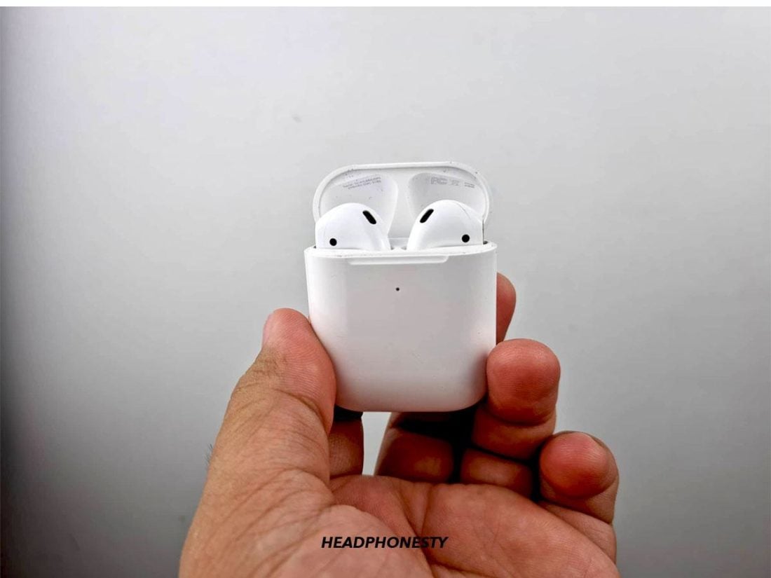 Holding AirPods with the case open