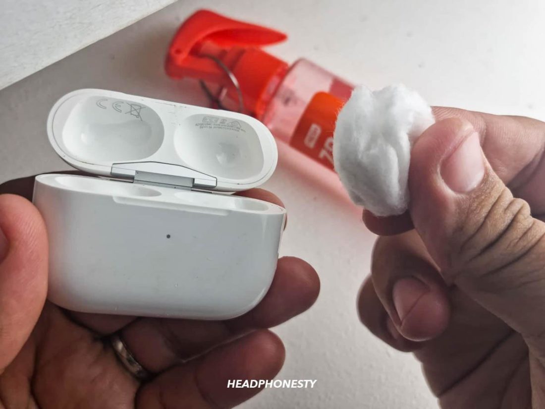 Using cotton balls damp with alcohol to clean AirPods case