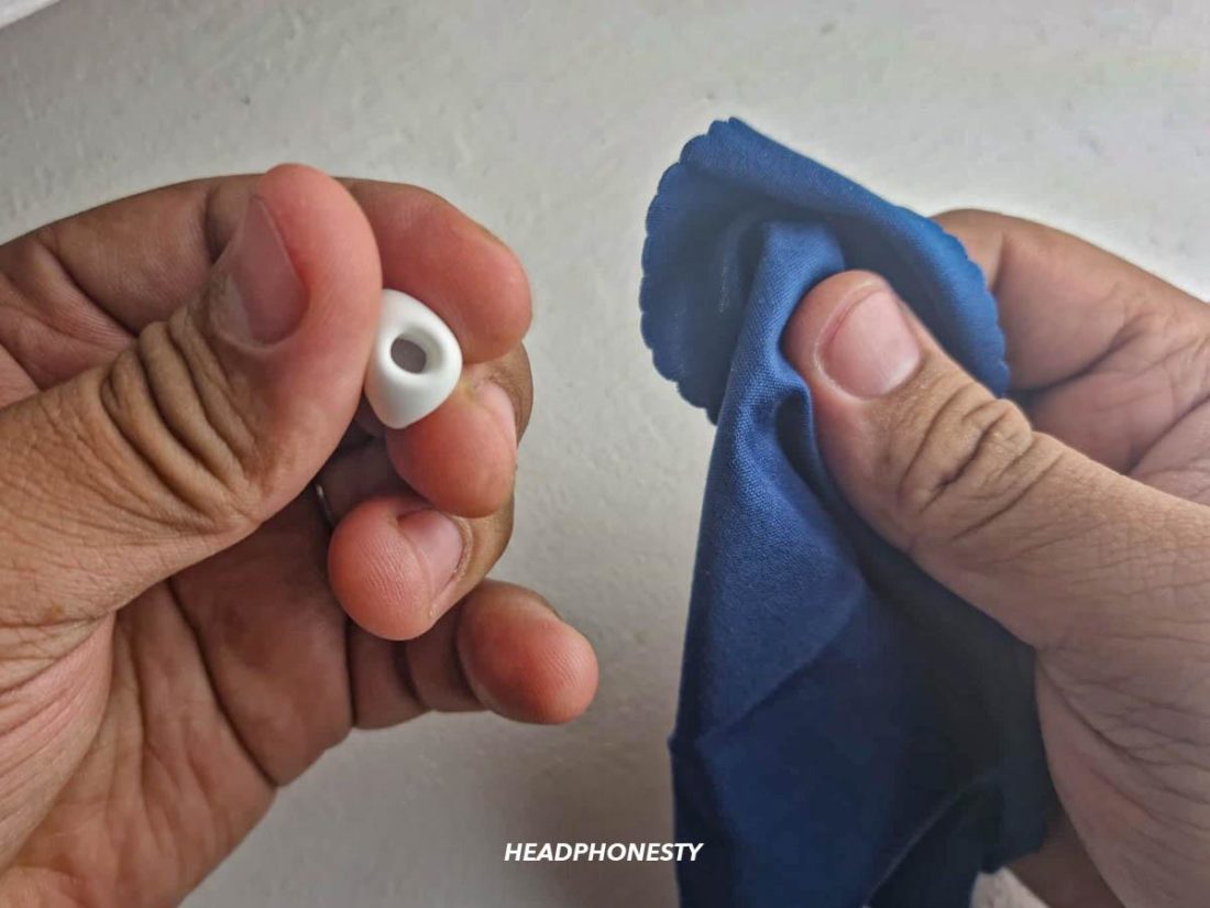Wiping AirPods Pro tips with lint-free cloth