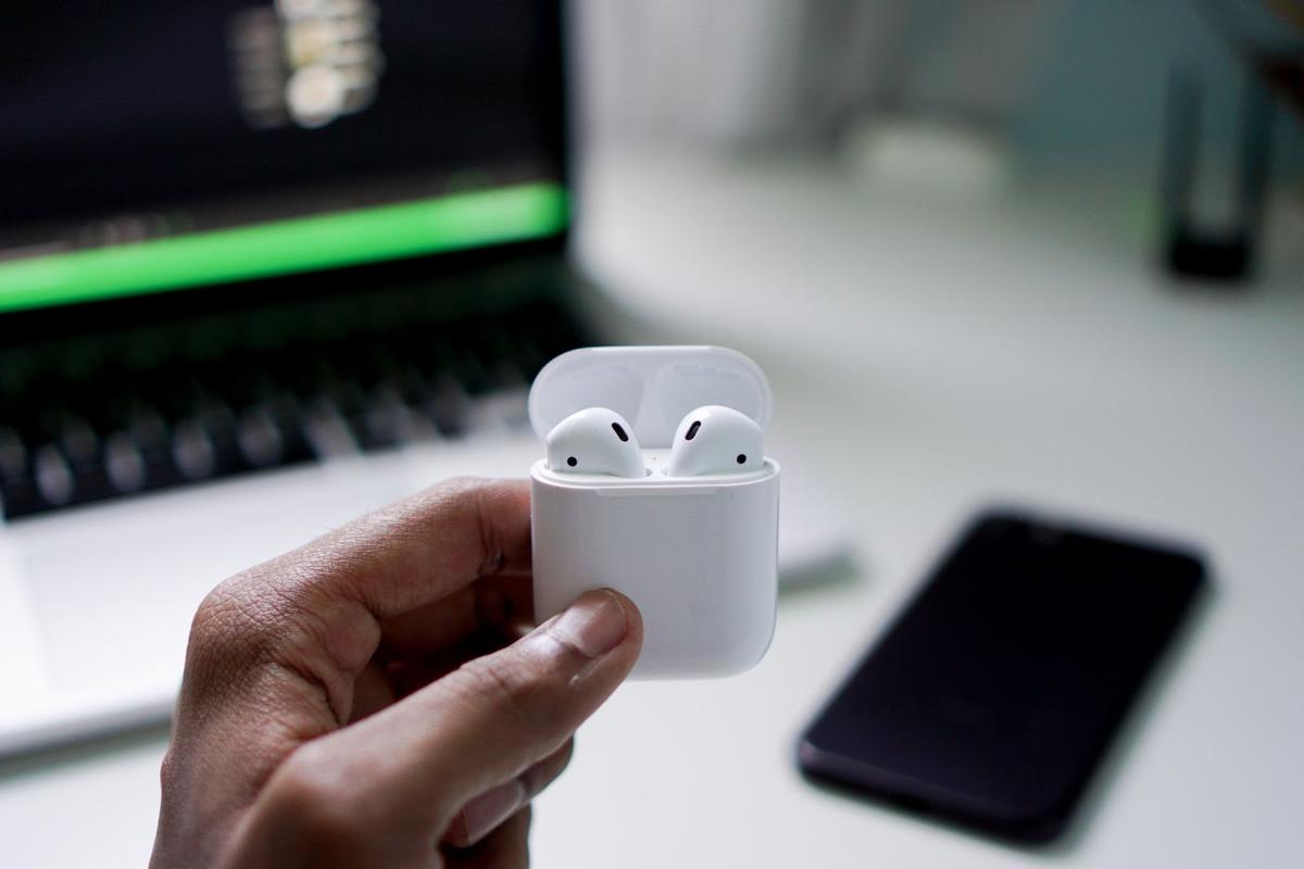 A person tries to connect the AirPods to their Apple devices. (From: Unsplash)