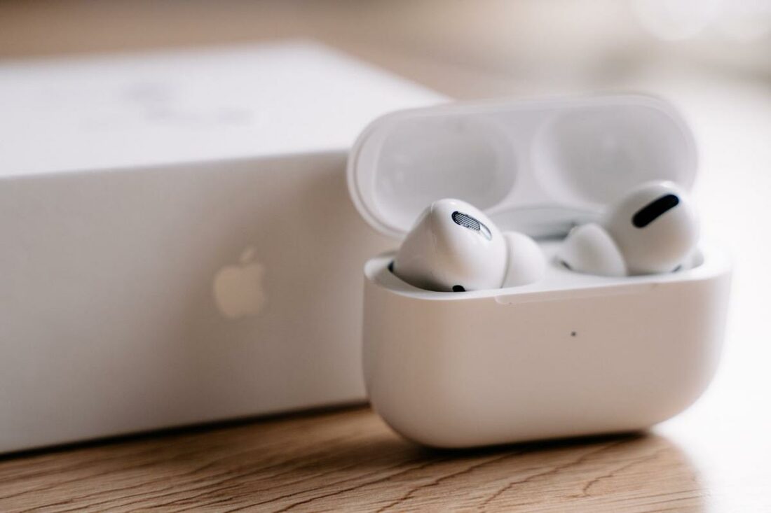 A pair of AirPods Pro alongside the Macbook they are connected to. (From: Unsplash)