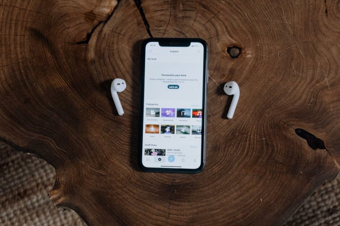 AirPods placed alongside the iPhone they are connected to. (From: Pexels)