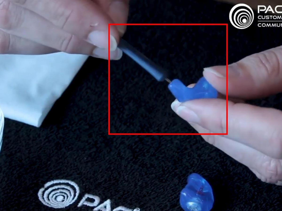 Removing foreign material in earplugs' holes (From: Facebook/Pacific Ears)