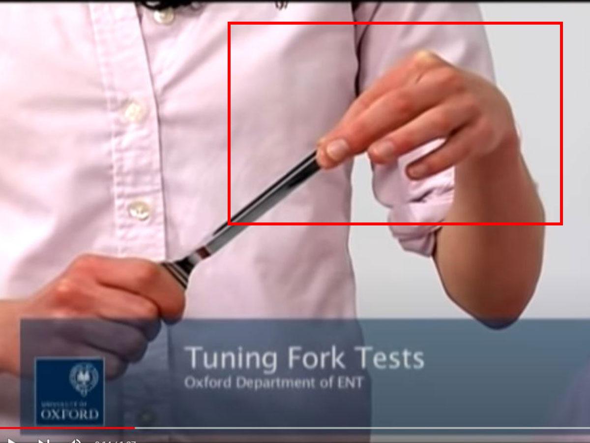 Flick the tuning fork prongs between your fingers. (From: Youtube/Oxford Medical Education)