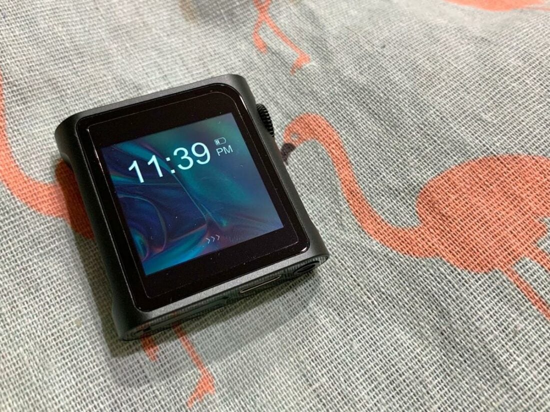 The lock screen features a clock and battery level. Swiping to the right unlocks the DAP.