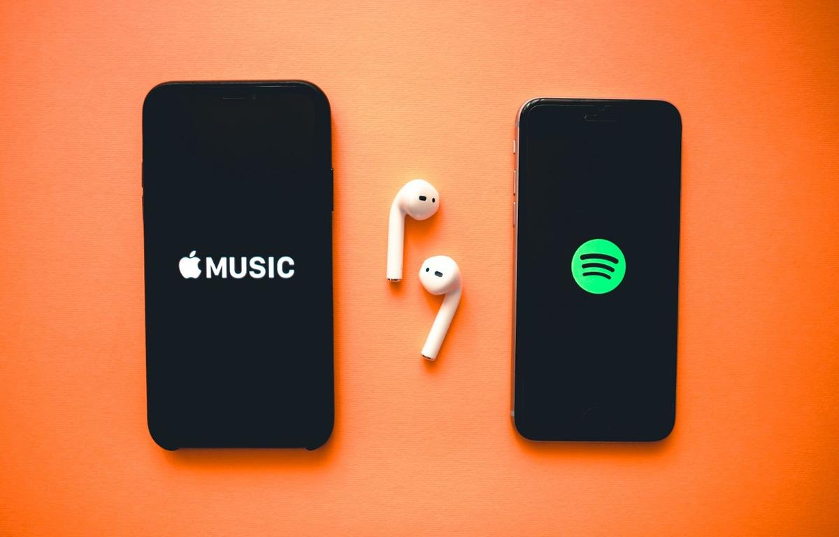 Two different devices showing using Spotify and Apple Music, respectively.