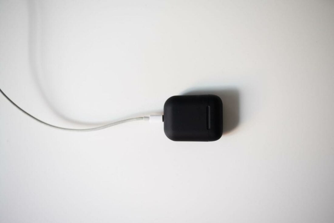 An older AirPods model charging via lightning cable. (From: Pexels)