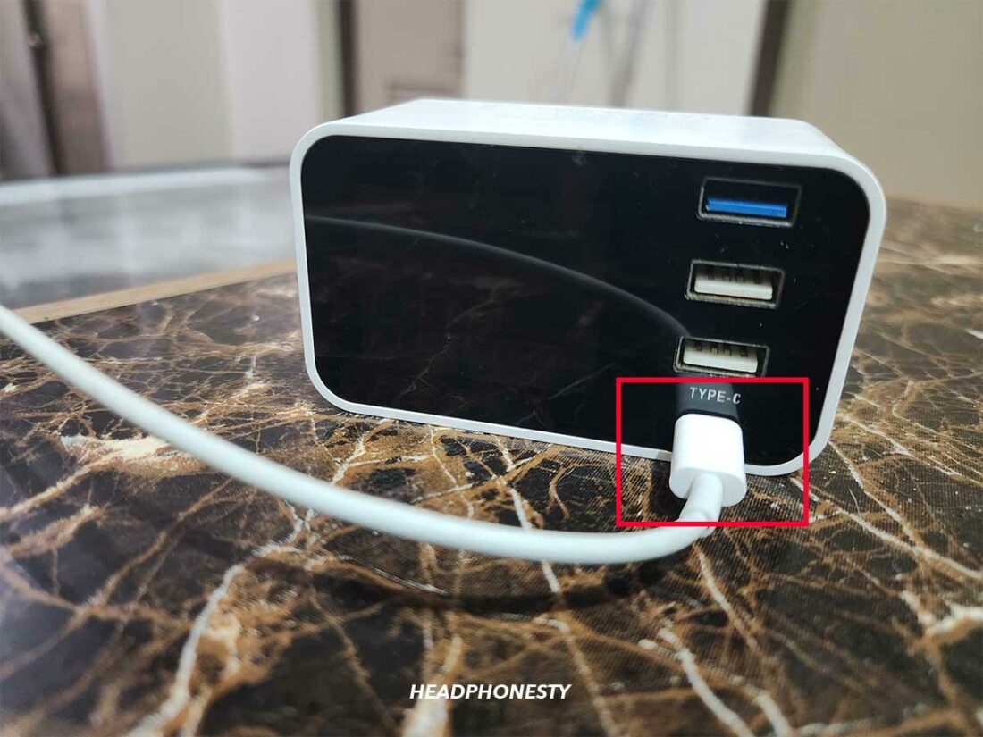 Plugging the lightning cable into a charging dock.