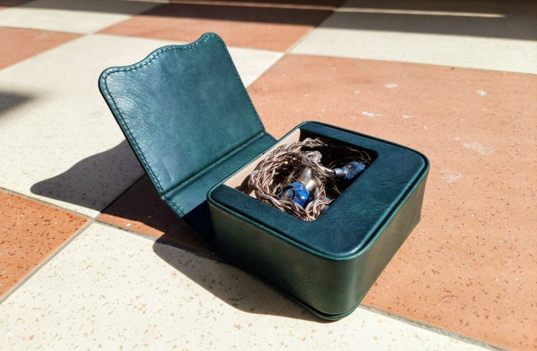 The accessories and IEMs fit snugly inside the pine green pleather case.