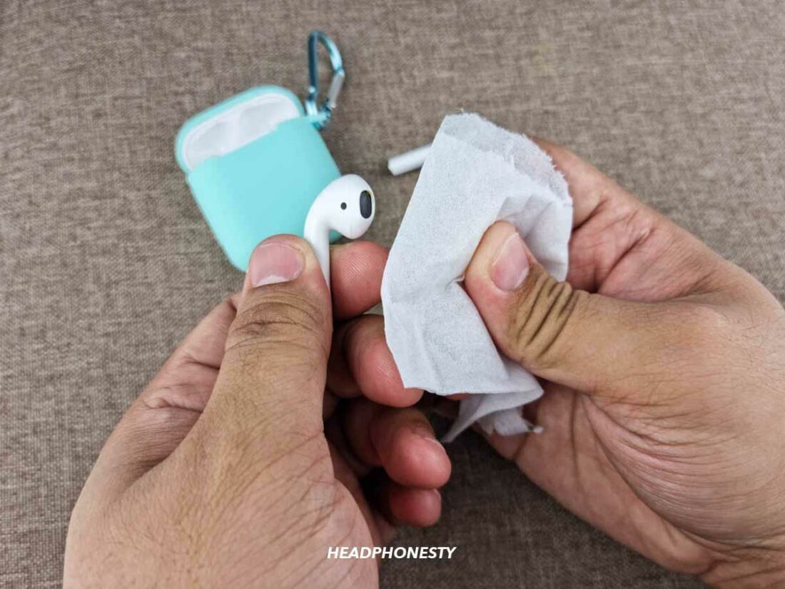 Use a dry lint-free fabric and clean the tail of the AirPods.