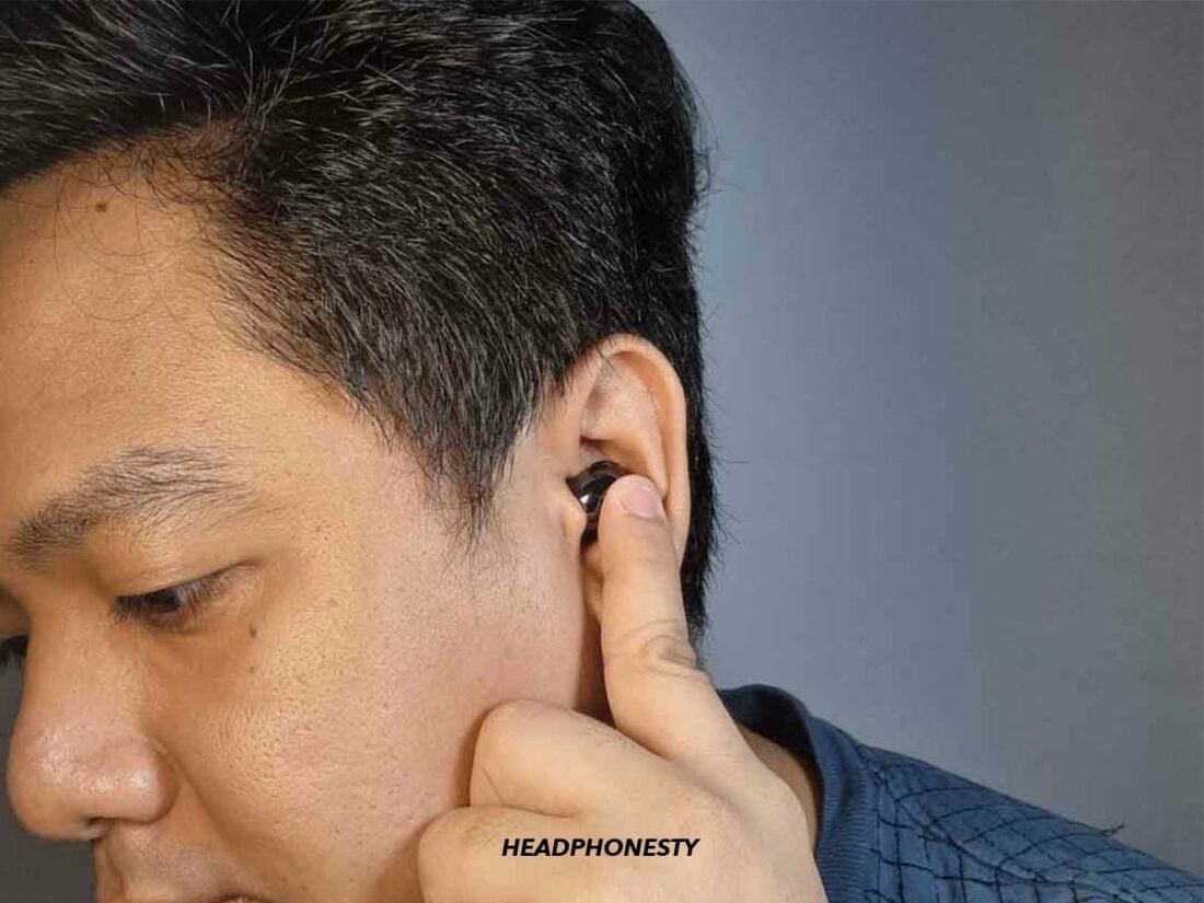 Touch and hold the sensors on both earbuds
