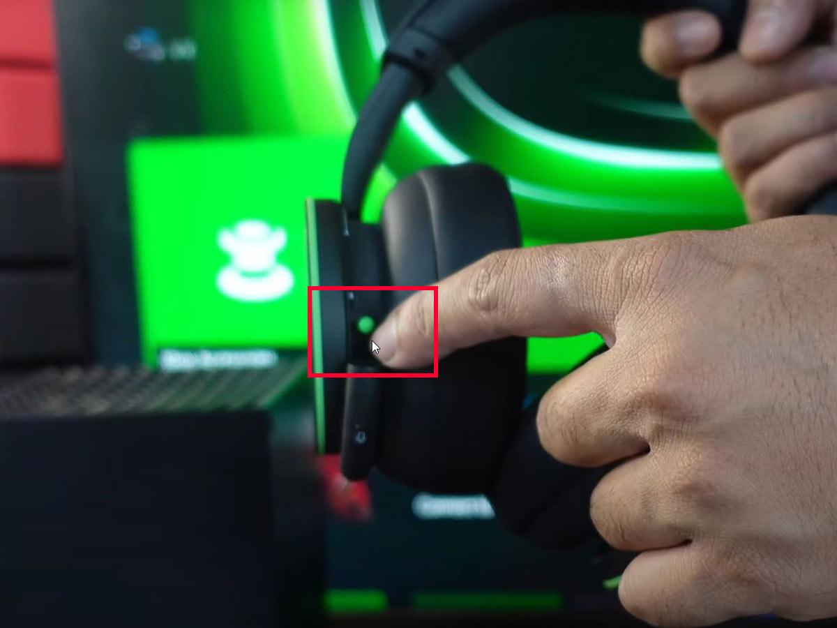 Press the green power button on your headset's left ear cup. (From: YouTube/Vicky's Blog)